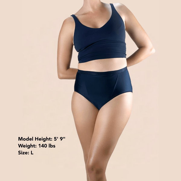 A model wearing Hem Support Wear's High Waisted Brief pelvic floor support underwear with her measurements at the bottom: height: 5 foot 9 inches, weight: 140 lbs, size: Large
