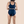 A woman shown from the back wearing Hem Support Wear's High Waisted Brief Pelvic Floor Support Underwear in black