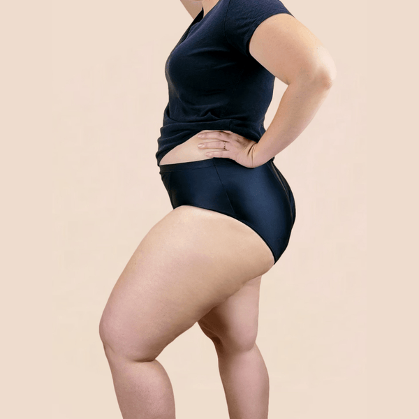A model shown from the side wearing Hem Support Wear's high waisted brief pelvic floor support underwear in size 1x.